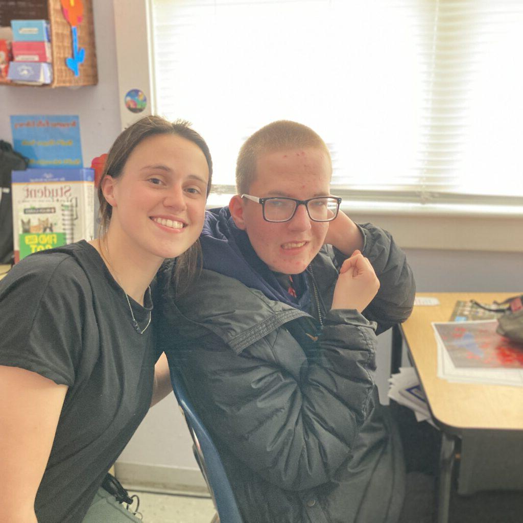 A student and teacher smiling in the Classroom